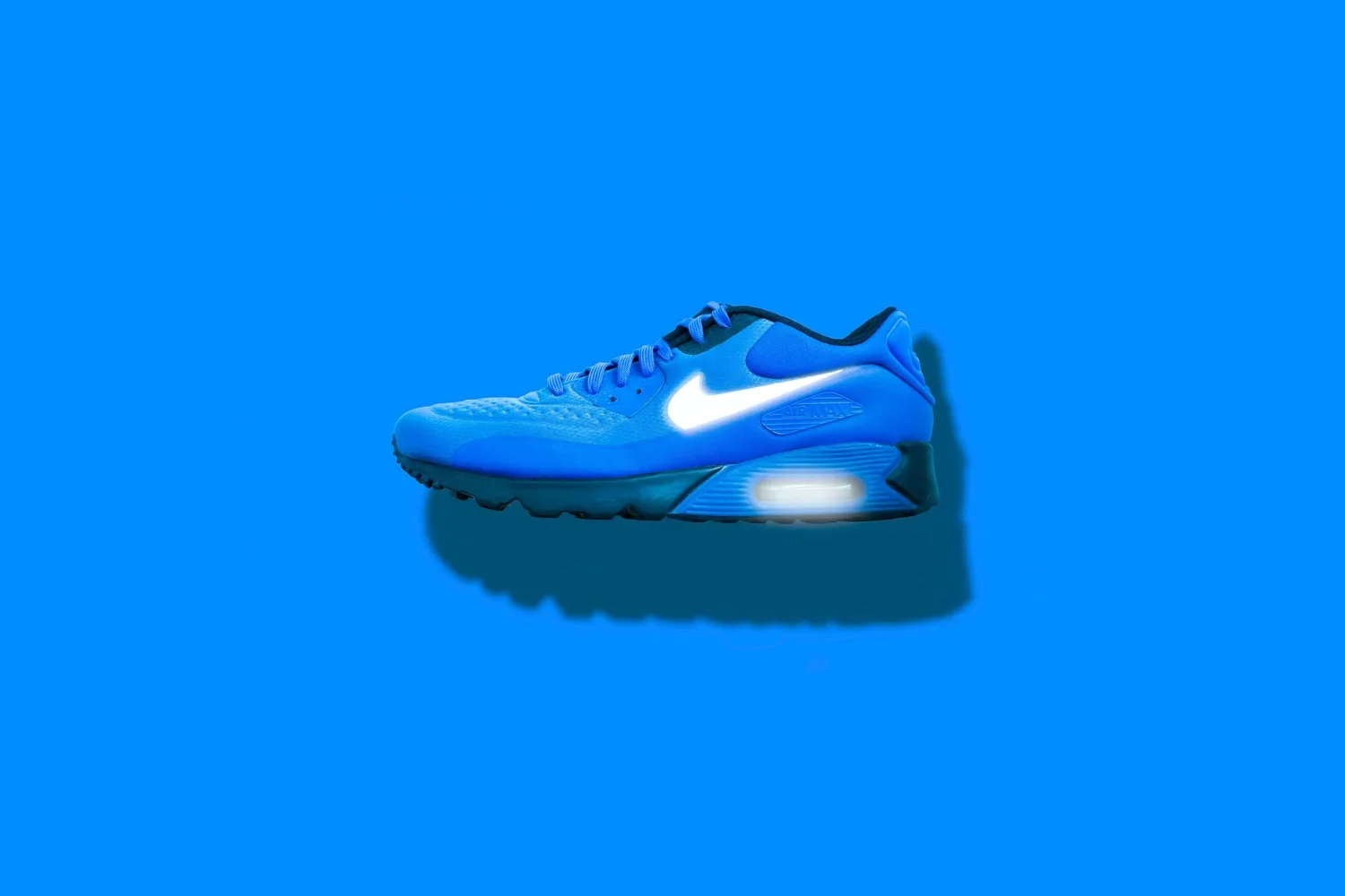Blue Nike Air Max sneaker with glowing Nike swoosh logo, set against a blue background.